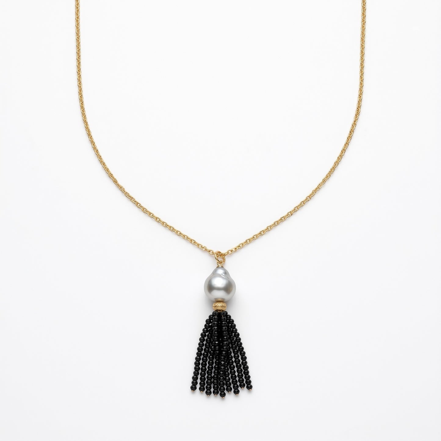 Trebor Style long necklace featuring a white Mabe pearl and a black spinel gemstone tassel on a gold-filled chain.