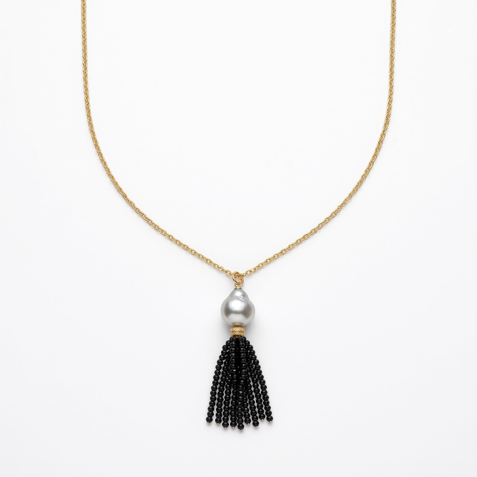 Trebor Style long necklace featuring a white Mabe pearl and a black spinel gemstone tassel on a gold-filled chain.