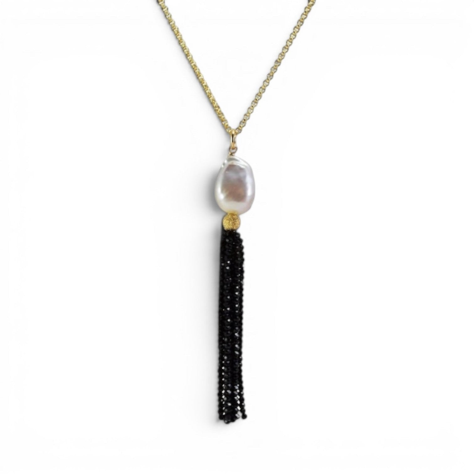Trebor Style long necklace featuring a white Mabe pearl and a black spinel gemstone tassel on a gold filled chain.