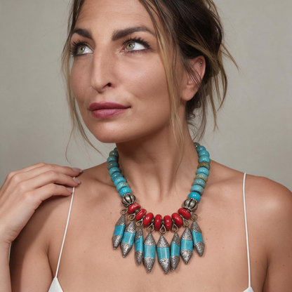 Trebor Style Masha Archer statement necklace with red baroque coral, turquoise rondelles, and Tibetan silver fringe.