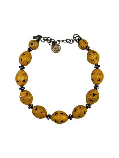 Trebor Style Masha Archer Cameroon gold wreath necklace featuring 24k gold plated bronze baskets and black accents.