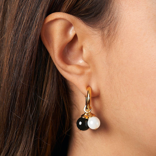 Trebor Style Mia earrings featuring gold hoops with detachable blue round and turquoise cube charms on a model