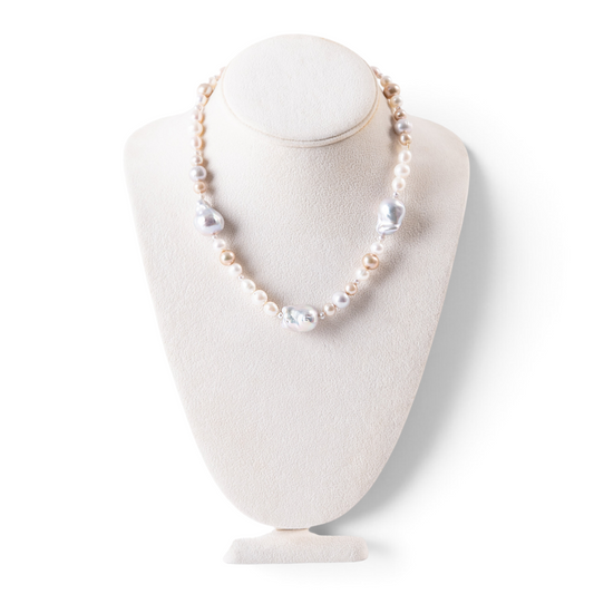 Trebor Style mixed color freshwater and baroque pearl necklace with 14k yellow gold hook closure on a display bust
