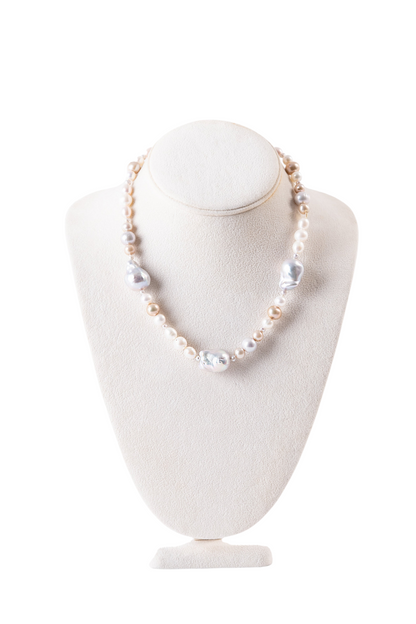 Trebor Style mixed color freshwater and baroque pearl necklace with 14k yellow gold hook closure on a display bust.
