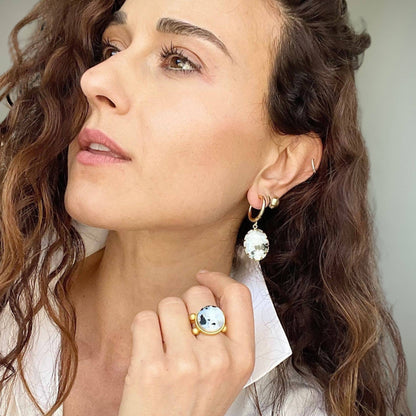 Trebor Style 16mm round-cut moonstone ring on a woman wearing a gold-filled band and matching drop earrings