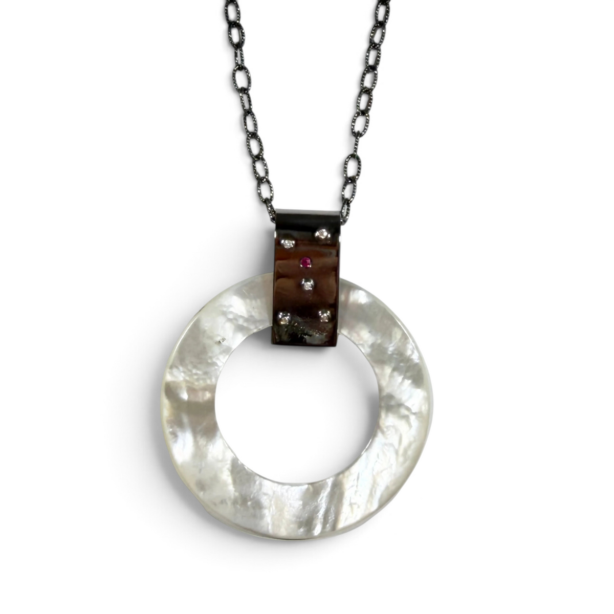 Trebor Style long necklace featuring a round mother of pearl pendant with diamond and ruby accents on oxidized silver