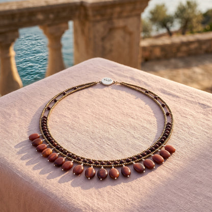 Trebor Style multi-strand beaded necklace with bronze seed beads, dark garnet accents, and dangling carnelian beads.