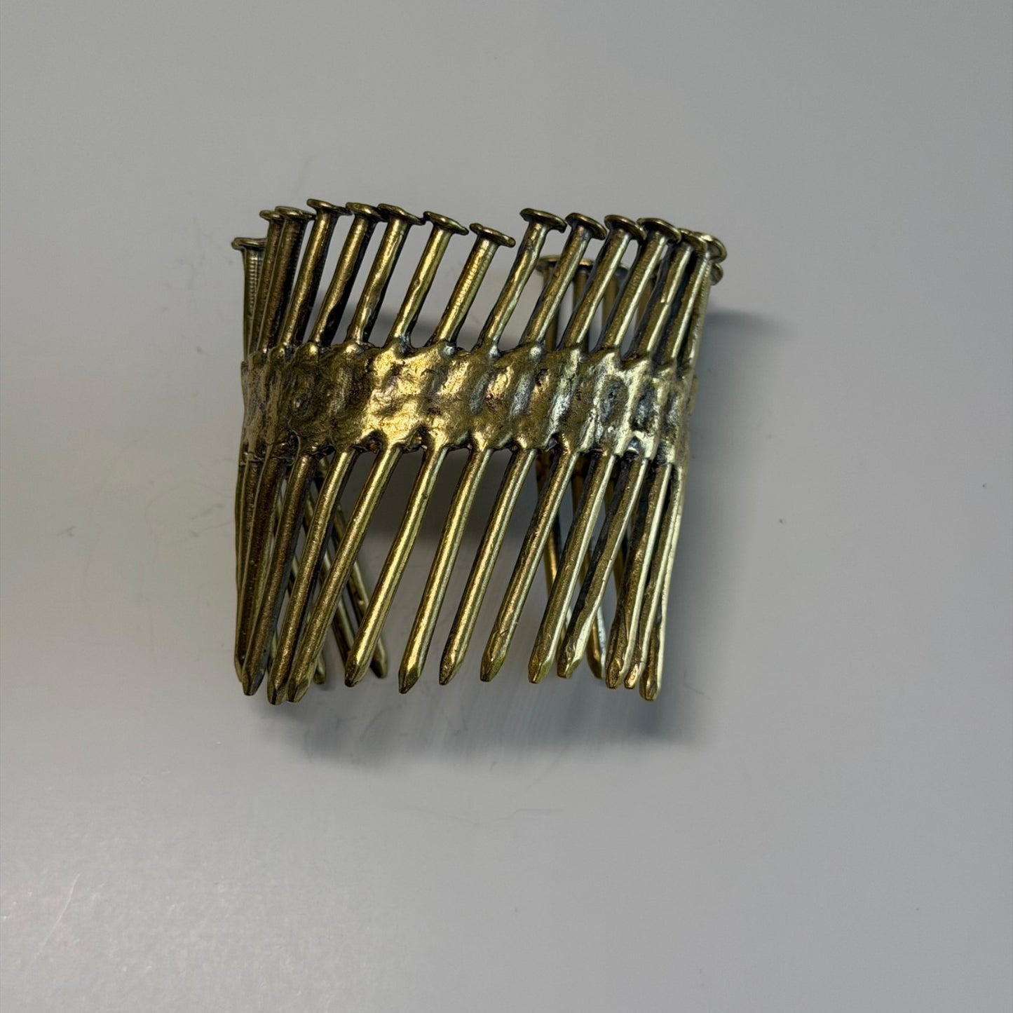Trebor Style industrial cuff bracelet made from reclaimed copper and zinc featuring a row of nail gun nail designs.