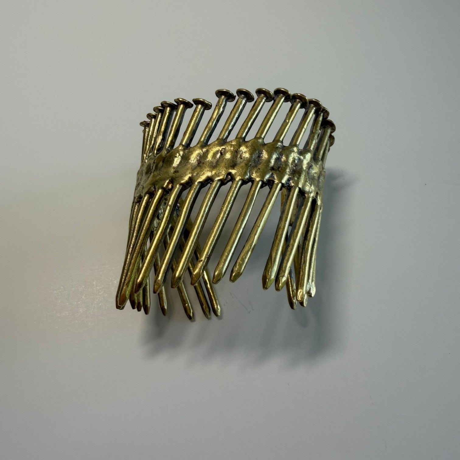 Trebor Style Nails Cuff made from reclaimed copper and zinc in a sculptural, industrial nail gun nail design.