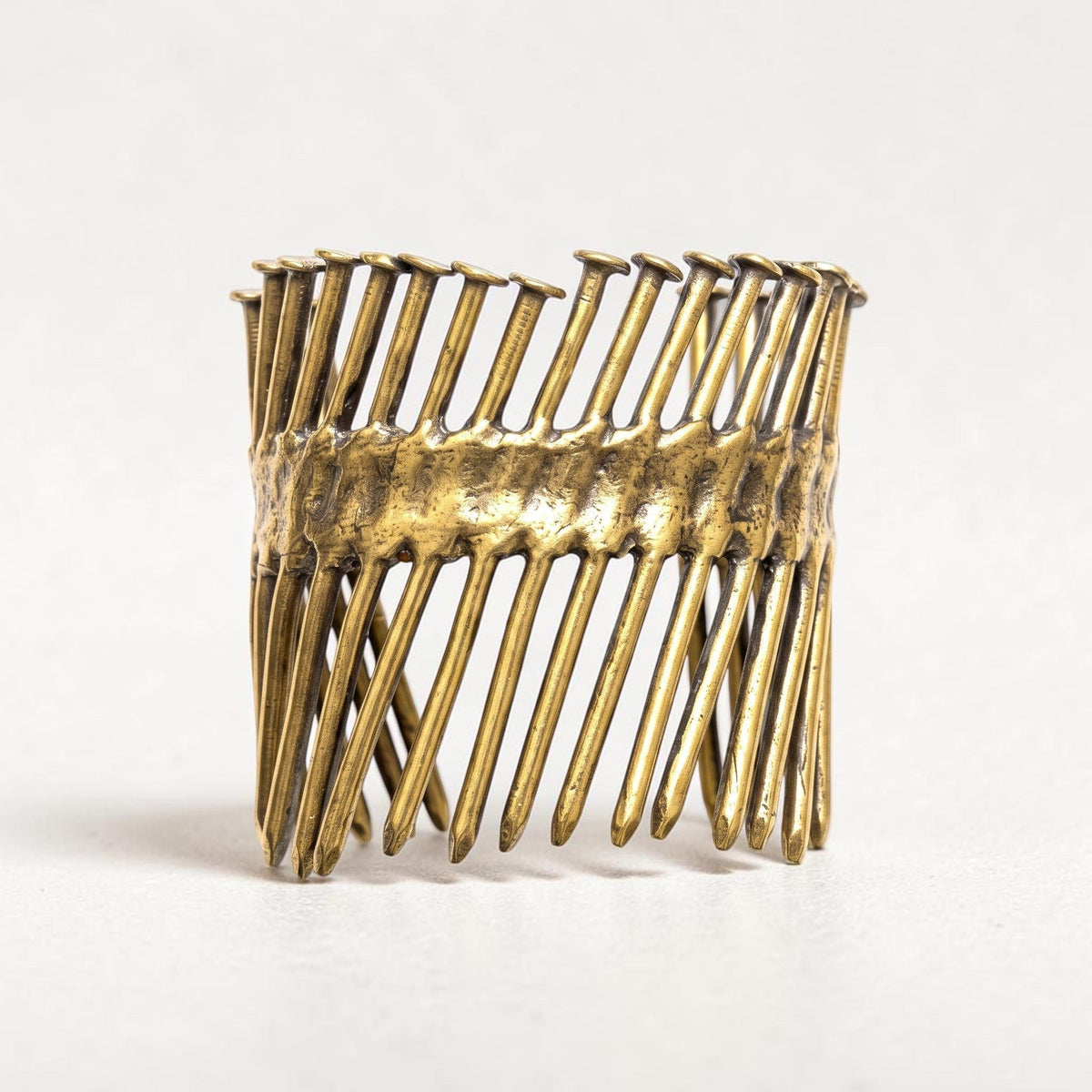 Trebor Style Nails Cuff made from reclaimed copper and zinc with an industrial, sculptural nail design.