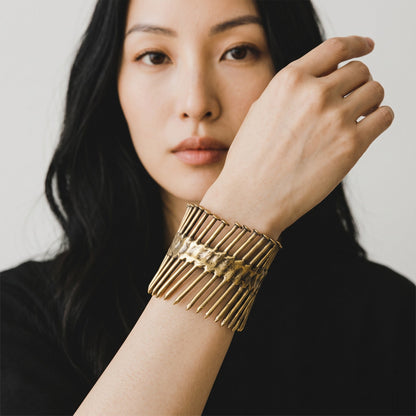 Trebor Style Nails Cuff made of reclaimed copper and zinc, worn on a woman's wrist in an industrial, edgy design.