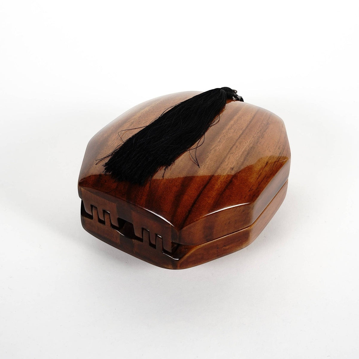 Trebor Style octagon handbag handcrafted from natural acacia wood with a decorative black tassel accent.