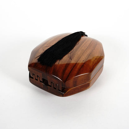 Trebor Style octagon handbag handcrafted from natural acacia wood with a decorative black tassel accent.