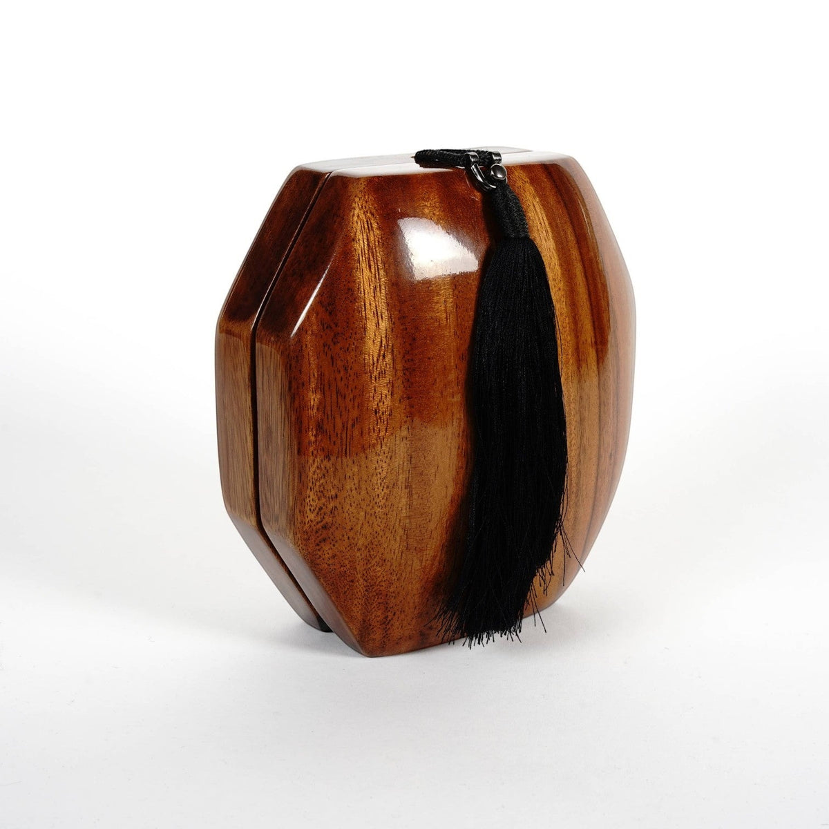 Trebor Style octagon handbag handcrafted from natural acacia wood with a black tassel accent on a white background.