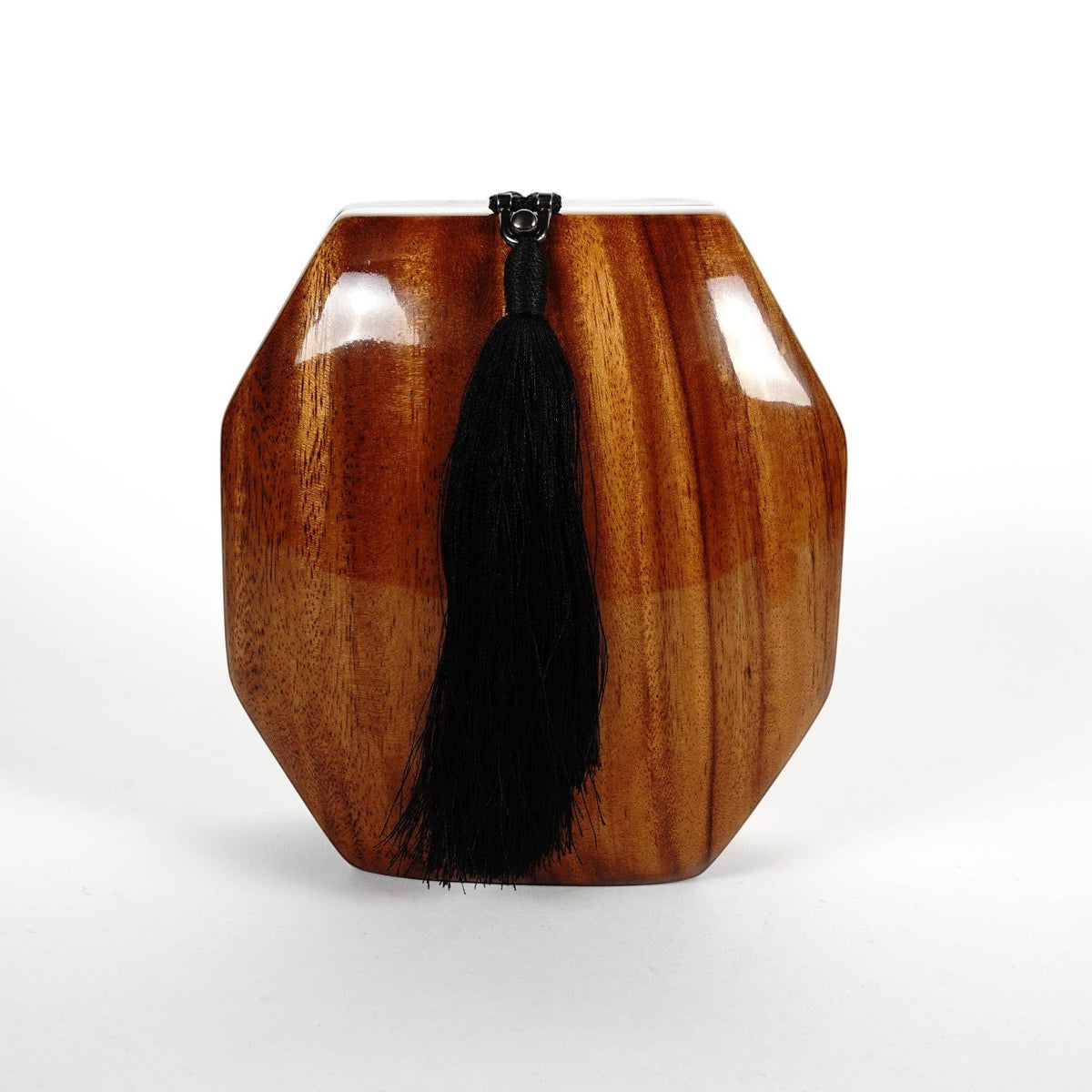 Trebor Style octagon handbag handcrafted from natural acacia wood with a decorative black tassel and shoulder strap.