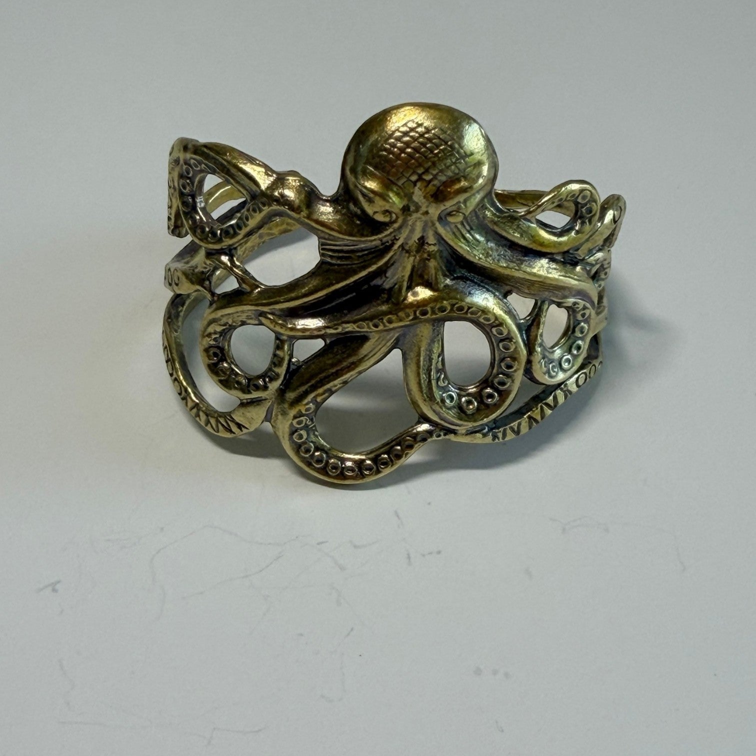 Trebor Style octopus cuff bracelet in antique brass with detailed tentacles wrapping around the wrist