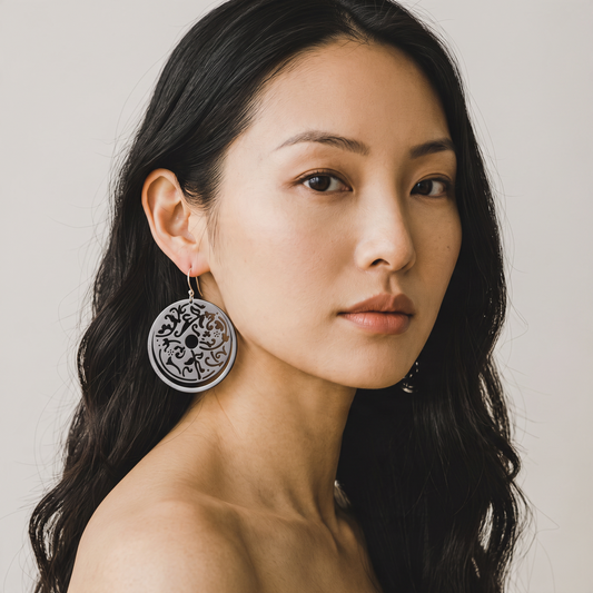 Trebor Style oxidized sterling silver filigree circle drop earrings worn by a woman with long dark hair