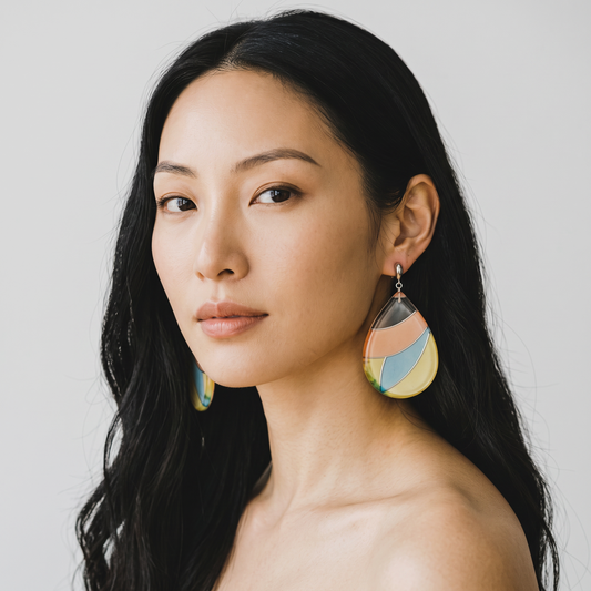 Trebor Style pastel teardrop earrings featuring silk enclosed in acrylic with sterling silver posts on a model.