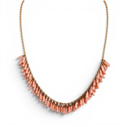 Trebor Style peach coral bead necklace with gold filled chain and fringe design on a white background.