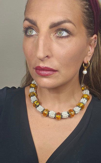 Trebor Style Masha Archer necklace featuring freshwater pearls and Baltic amber rondelles on a model