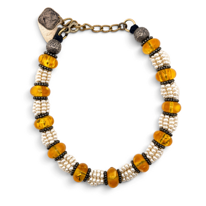 Trebor Style Masha Archer necklace featuring eight strands of freshwater pearls, Baltic amber, and hammered silver.