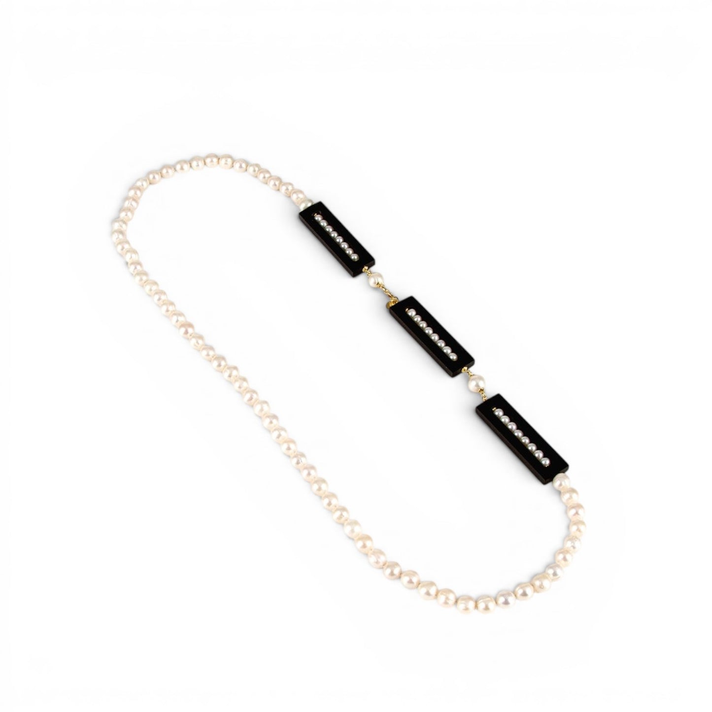 Trebor Style long white freshwater pearl necklace featuring three rectangular black ebony accents with inlaid pearls.