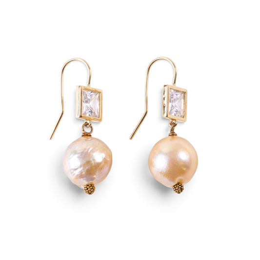 Trebor Style pink Edison pearl drop earrings with square bezel-set crystals in 14k yellow gold on hook backings.