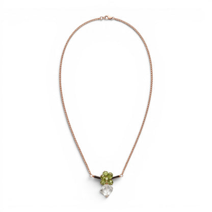 Trebor Style bar necklace featuring green peridot, dark tourmaline, and a praisiolite pendant on a gold wheat chain.