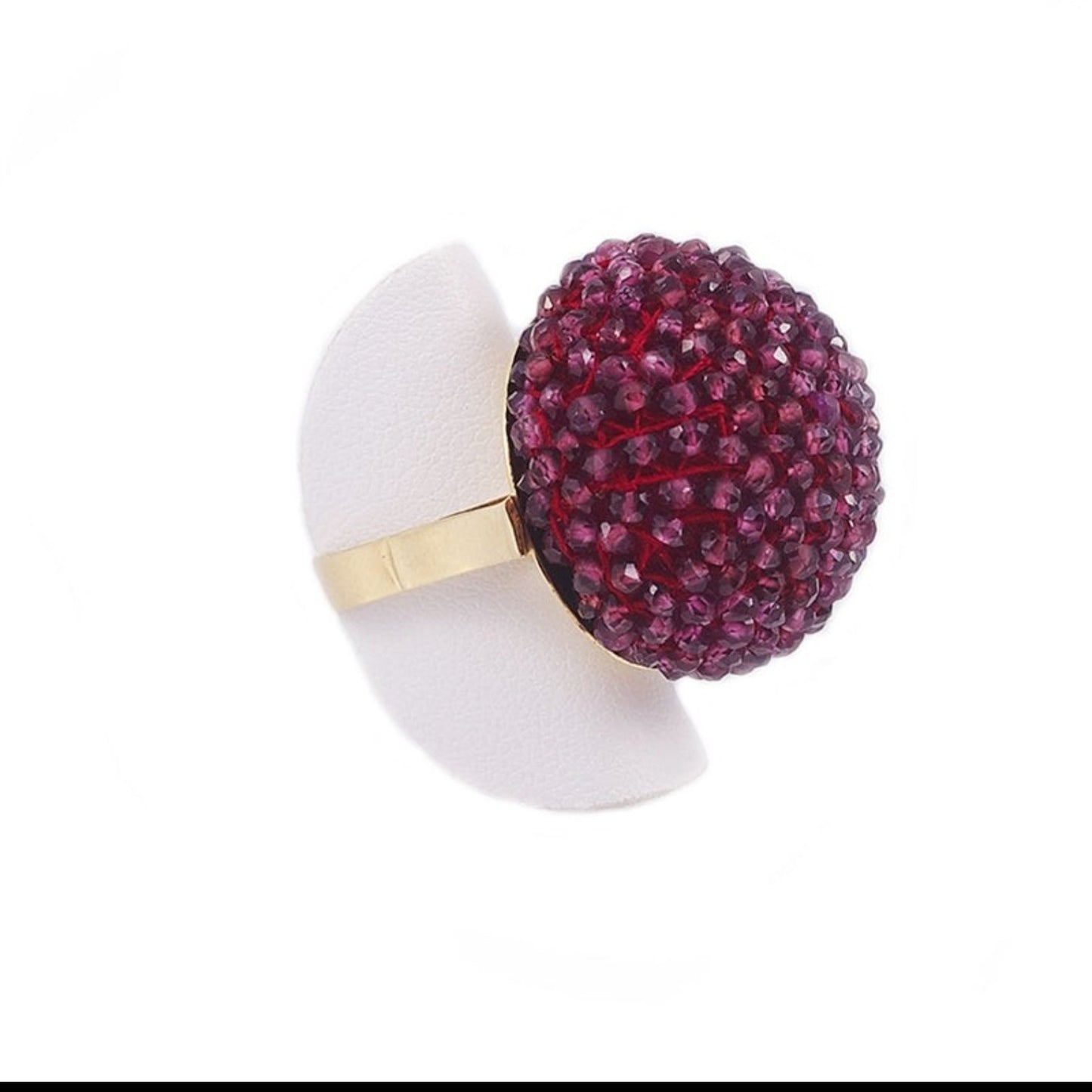 Trebor Style cocktail ring featuring a large sphere of faceted purple garnet beads on an 18k yellow gold band.