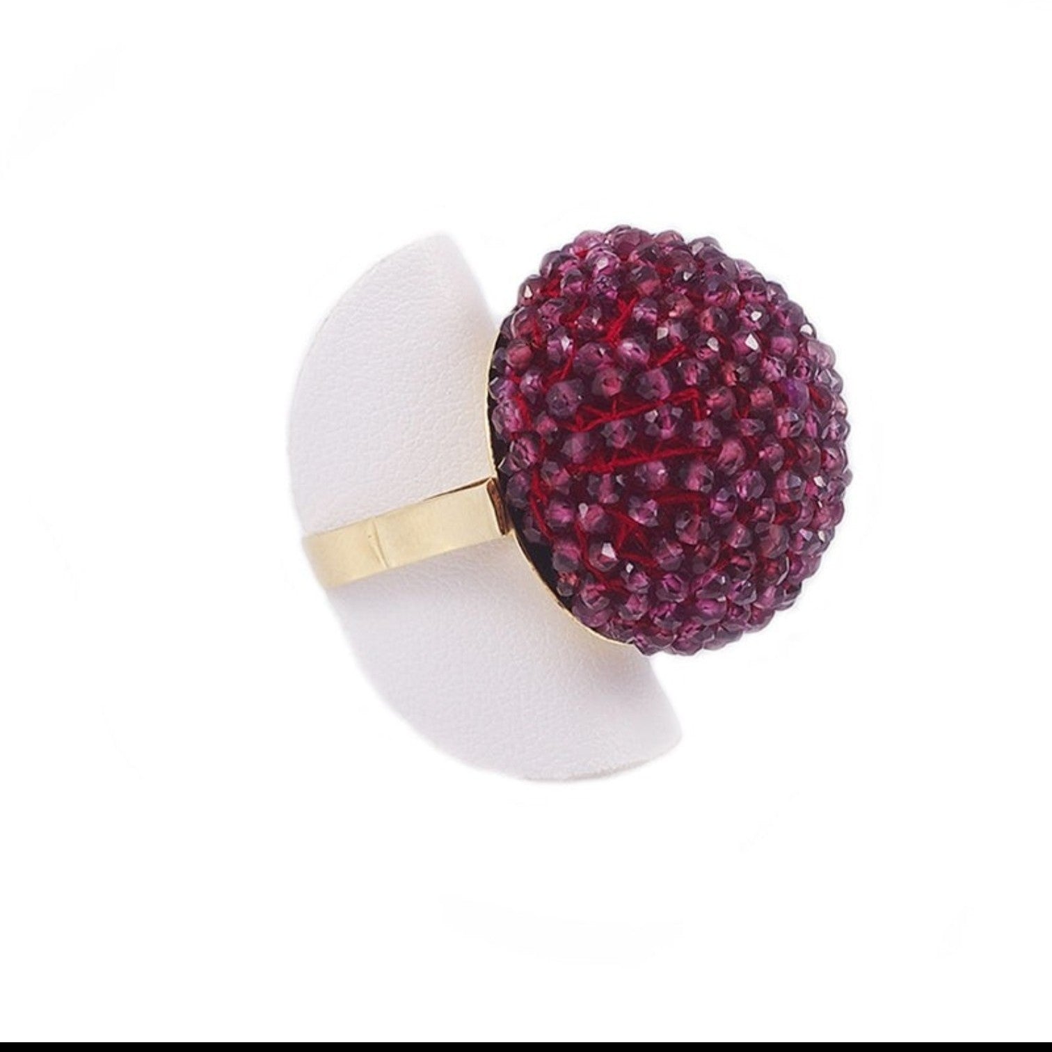 Trebor Style cocktail ring featuring a large sphere of faceted purple garnet beads on an 18k yellow gold band.