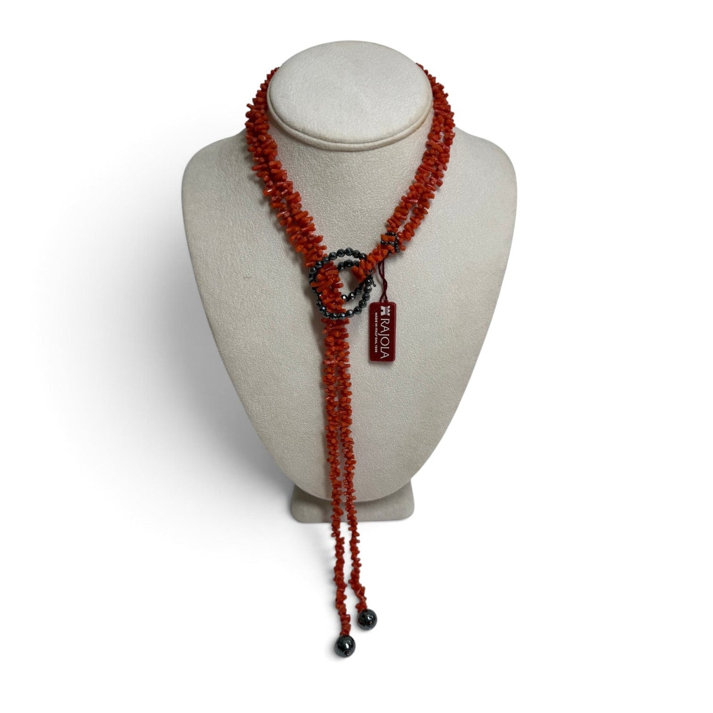 Trebor Style RAJOLA multi-strand necklace featuring red coral chips and dark faceted hematite beads on a display bust.