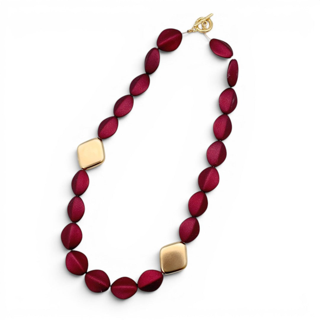 Trebor Style Loni short statement necklace with dark red oval acrylic beads and 24k gold-plated diamond-shaped beads.