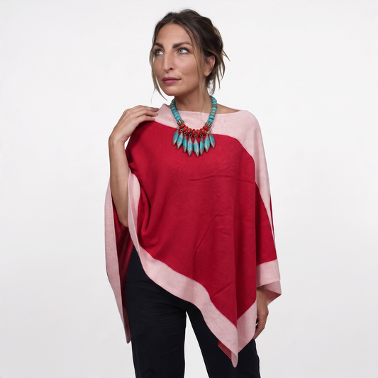 Trebor Style two-tone red and pink cashmere blend poncho worn by a woman with a statement turquoise necklace