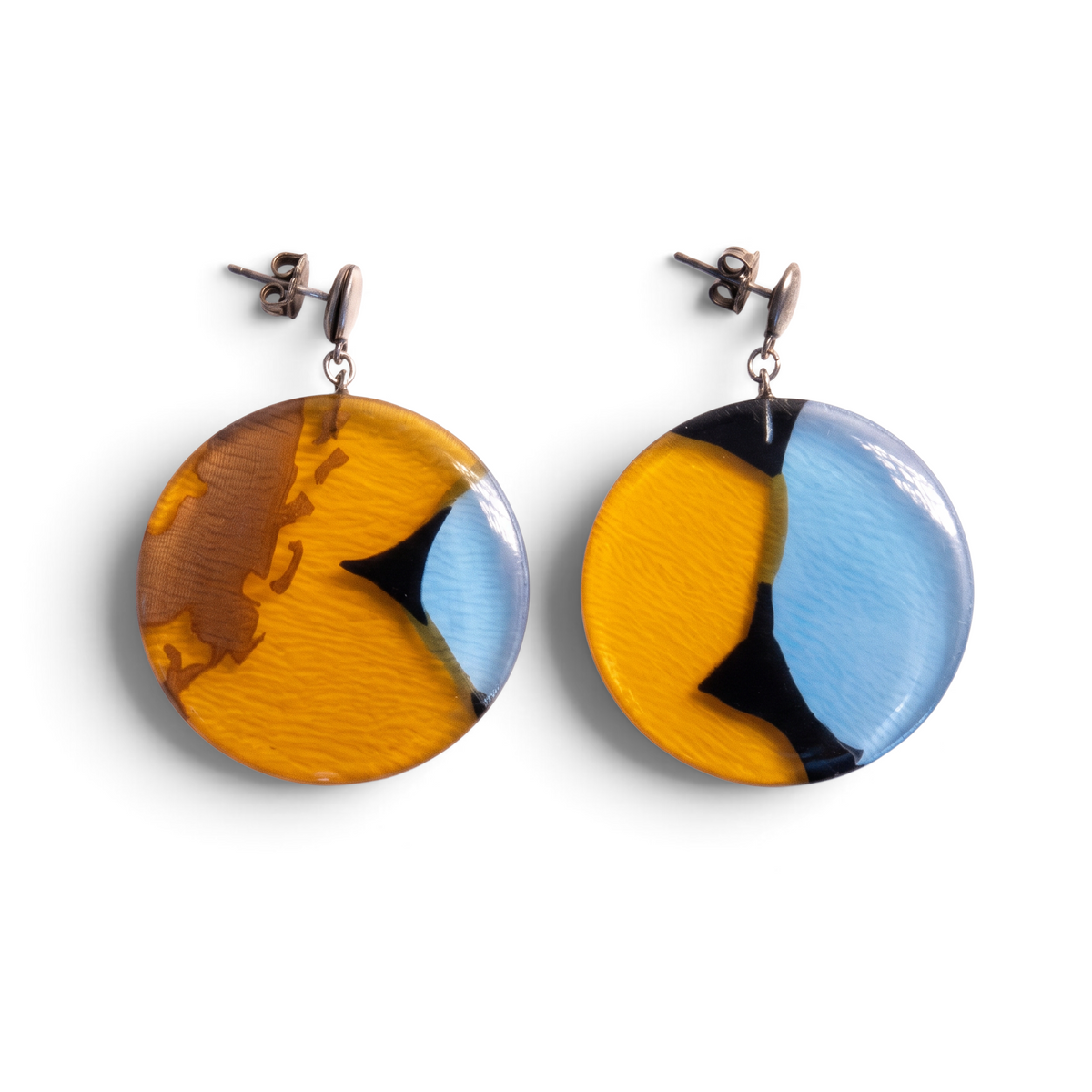 Trebor Style round drop earrings featuring blue, amber, and black silk fabric encased in clear acrylic with silver posts