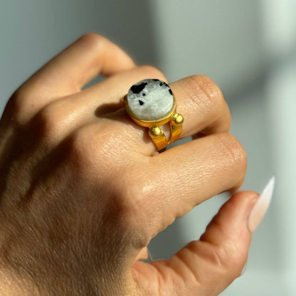 Trebor Style 16mm round moonstone ring with a chunky gold filled adjustable band worn on a hand