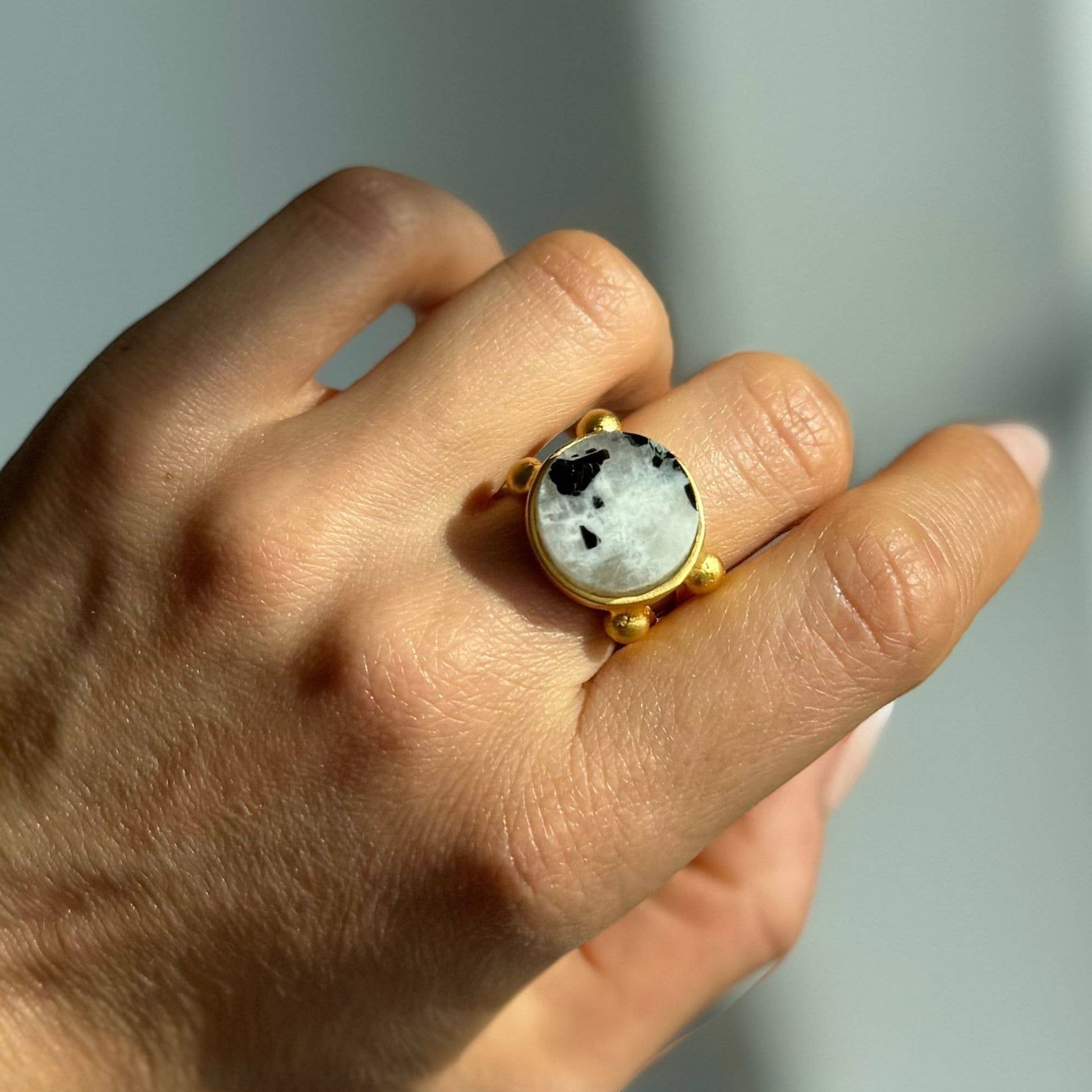 Trebor Style 16mm round moonstone ring with a chunky gold filled adjustable band worn on a finger