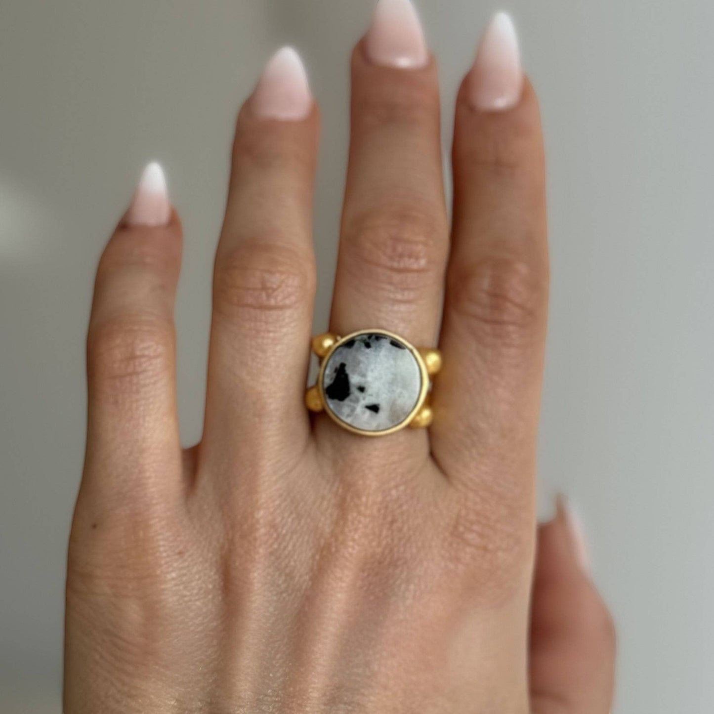 Trebor Style 16mm round moonstone ring with a chunky gold filled adjustable band worn on a finger