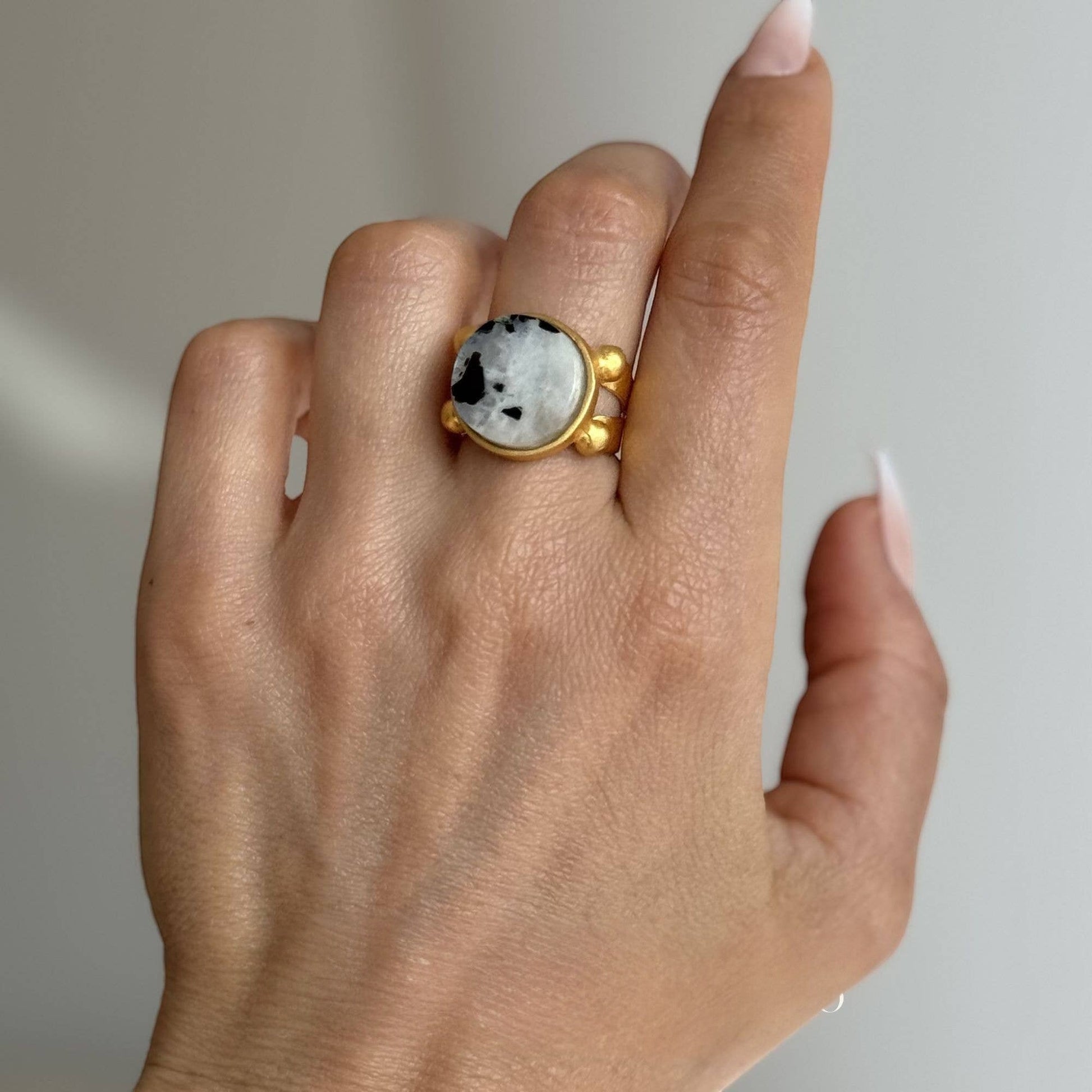 Trebor Style 16mm round moonstone ring with a chunky gold filled adjustable band worn on a finger