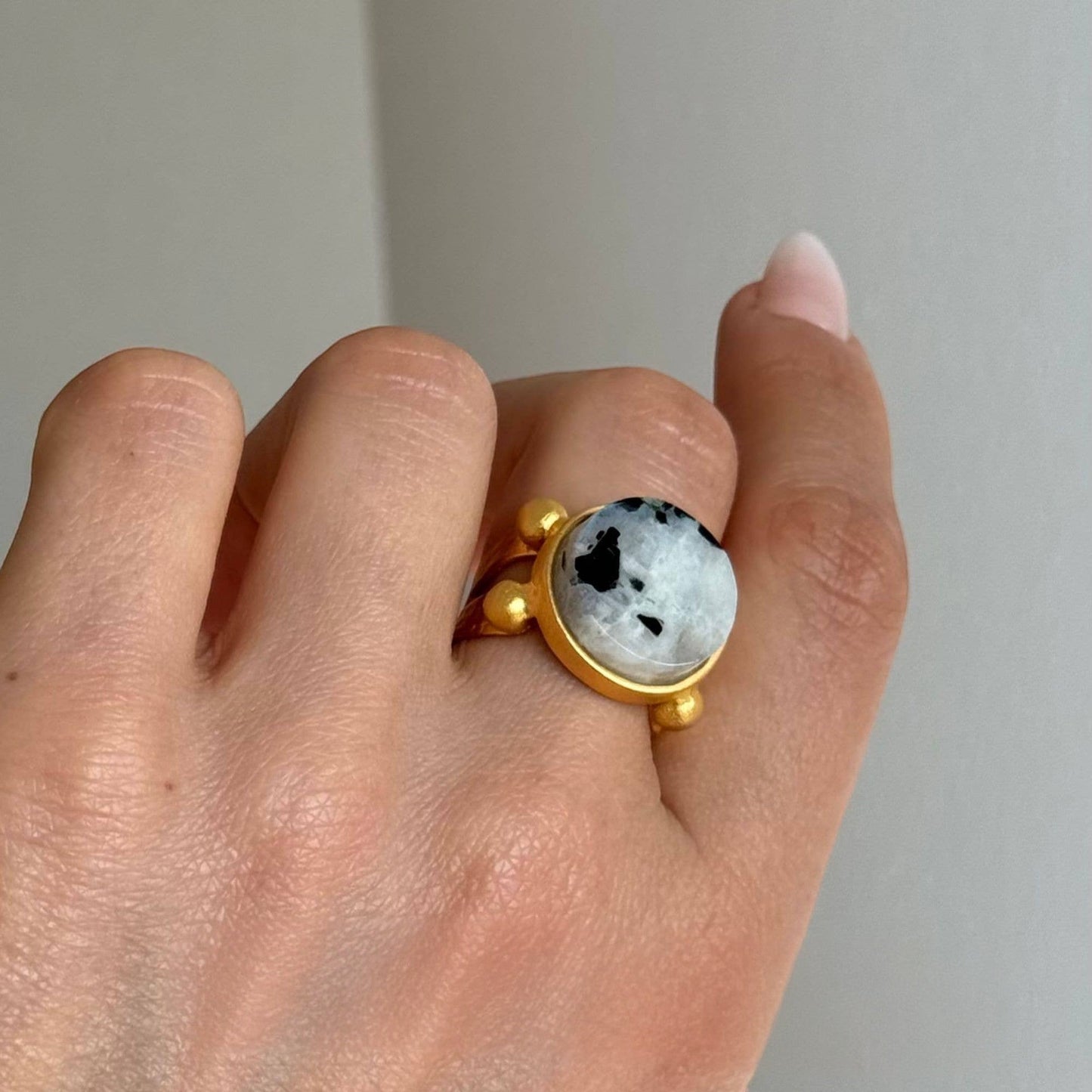 Trebor Style 16mm round moonstone ring with a chunky gold filled adjustable band worn on a finger