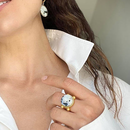 Trebor Style 16mm round moonstone ring on a woman wearing a white collared shirt and matching stone earrings