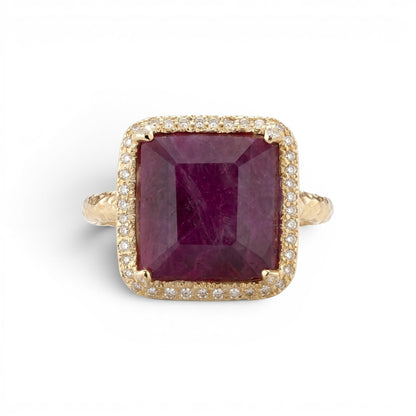 Trebor Style 14k gold cocktail ring featuring a large emerald-cut African ruby surrounded by a white diamond halo.