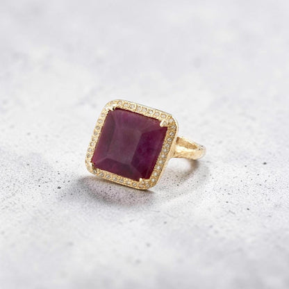 Trebor Style emerald-cut African ruby cocktail ring with a pavé diamond halo set in 14k gold.