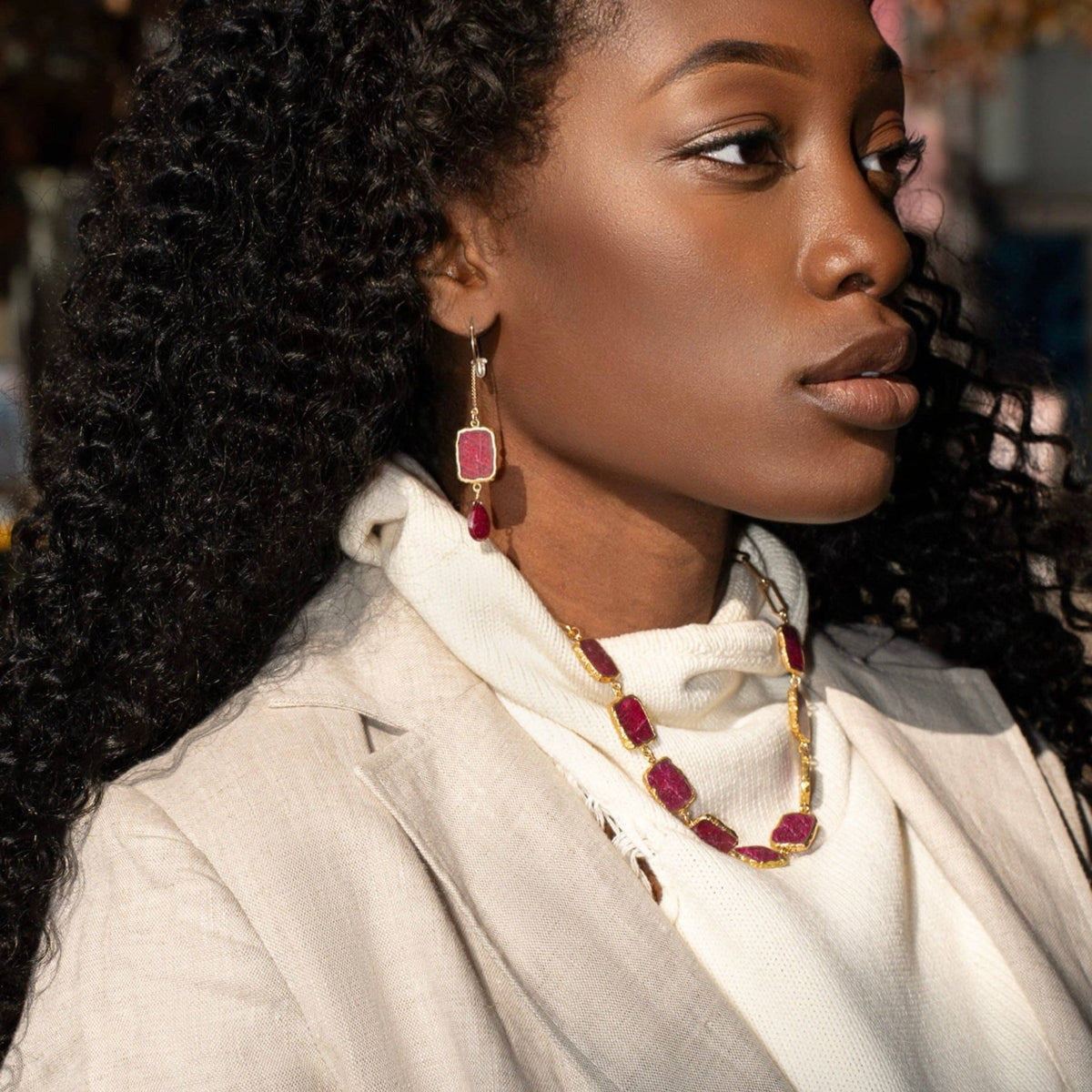 Trebor Style Longevity earrings featuring raw ruby slabs and garnet drops on 14k gold-filled chain worn by a model.