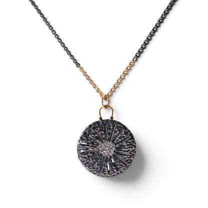 Trebor Style two-tone sand dollar pendant necklace in oxidized sterling silver and 14k gold with white sapphires.