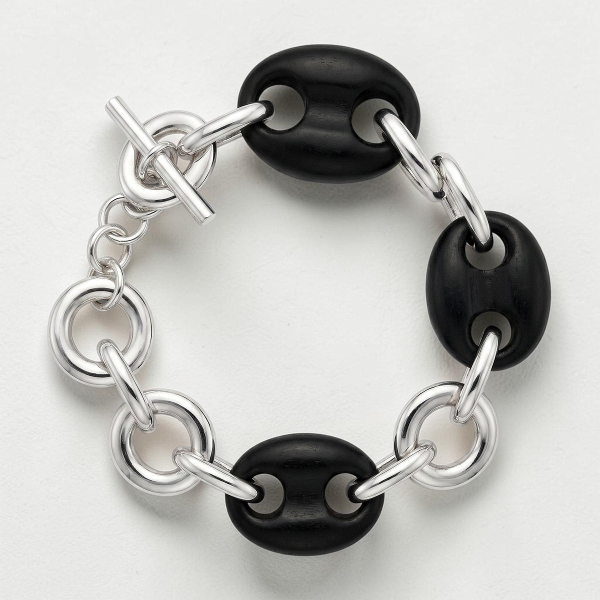 Trebor Style sterling silver and black ebony link bracelet with a toggle clasp, featuring hand-carved wood links.