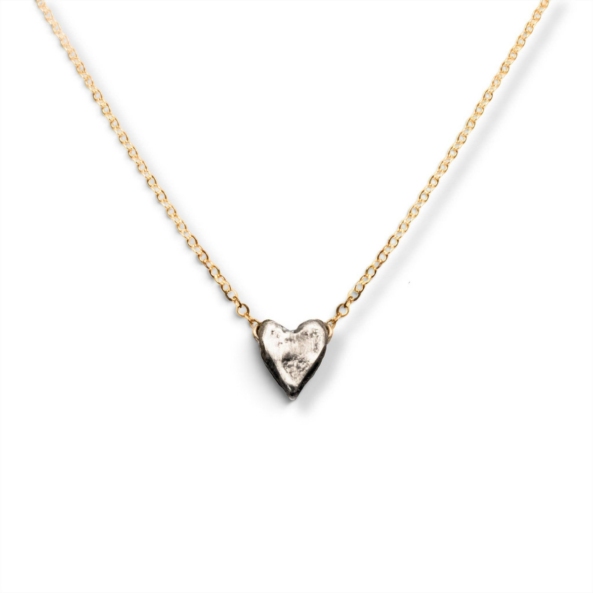 Trebor Style dainty heart necklace featuring a recycled sterling silver heart pendant on a 14kt gold-filled chain.