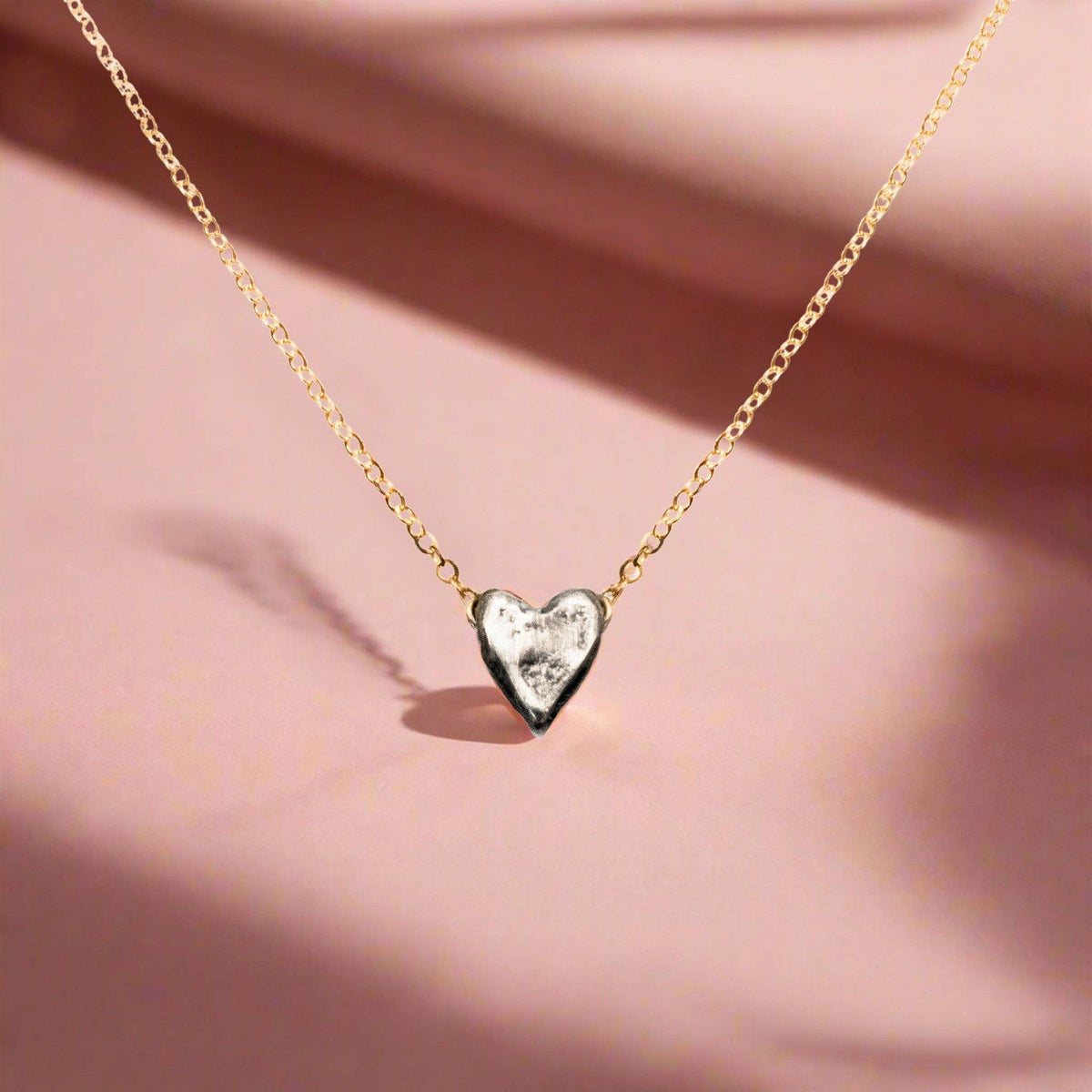 Trebor Style dainty heart necklace featuring a recycled sterling silver heart pendant on a 14kt gold-filled chain.