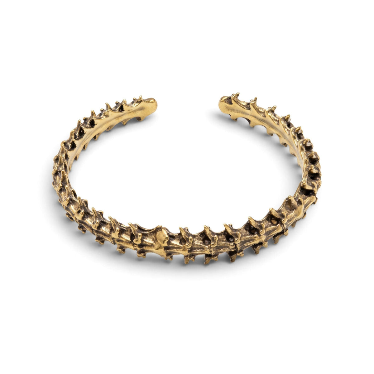 Trebor Style snake vertebrae bangle cast in reclaimed gold-toned metal with a textured, organic bone-like design.