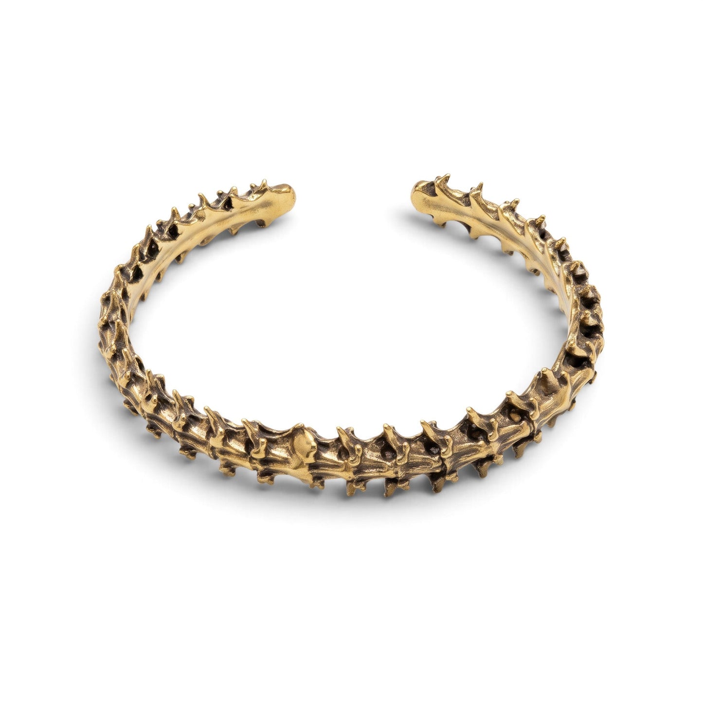 Trebor Style snake vertebrae bangle cast in reclaimed gold-toned metal with a textured, organic bone-like design.