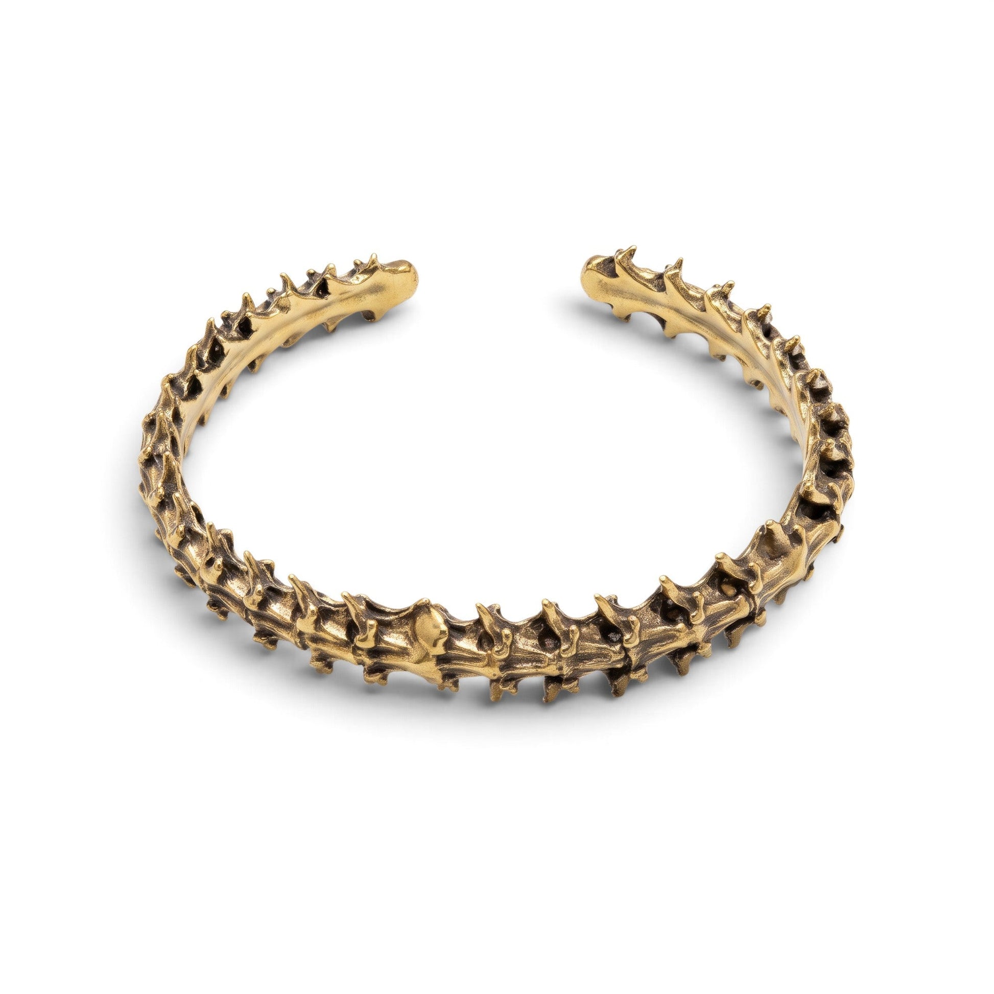 Trebor Style snake vertebrae bangle cast in reclaimed gold-toned metal with a textured, organic bone-like design.